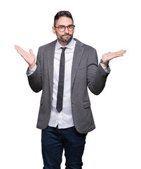 Young handsome business man over isolated background clueless and confused expression with arms and hands raised. Doubt concept.