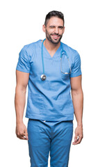 Fototapeta premium Handsome young doctor surgeon man over isolated background winking looking at the camera with sexy expression, cheerful and happy face.