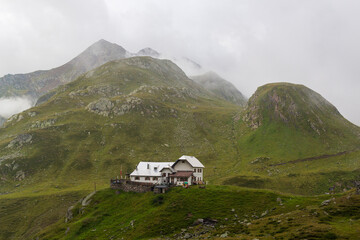 Mountain panorama and  alpine hut Lodnerhütte (Rifugio Cima Fiammante) in Texel group, South...