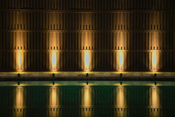 Brown Teak wood wall background fill warm lighting with green emerald water ground.