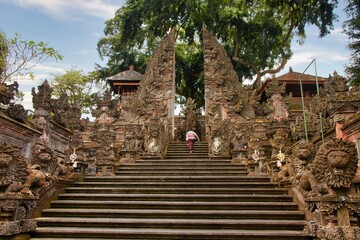 A beautiful entrance stairs in Balinese temple decorated with statues and pattens. Pura Dalem Temple in Ubud, Bali