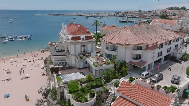 Aerial panoramic view of Praia da Rainha and historic city centre of Cascais, Portugal. Beautiful luxury hotels by the beach in Cascais.