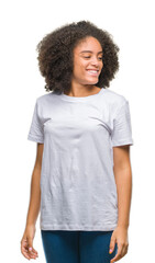 Young afro american woman over isolated background looking away to side with smile on face, natural expression. Laughing confident.