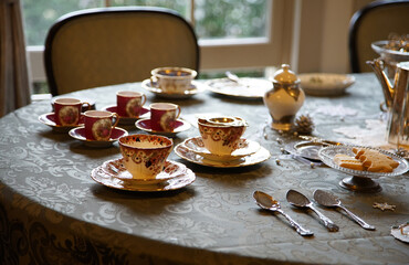 Tea cups and pots on the table at tea time