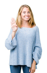 Beautiful young woman wearing blue sweater over isolated background Waiving saying hello happy and...