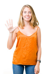 Beautiful young woman wearing orange shirt over isolated background showing and pointing up with fingers number five while smiling confident and happy.