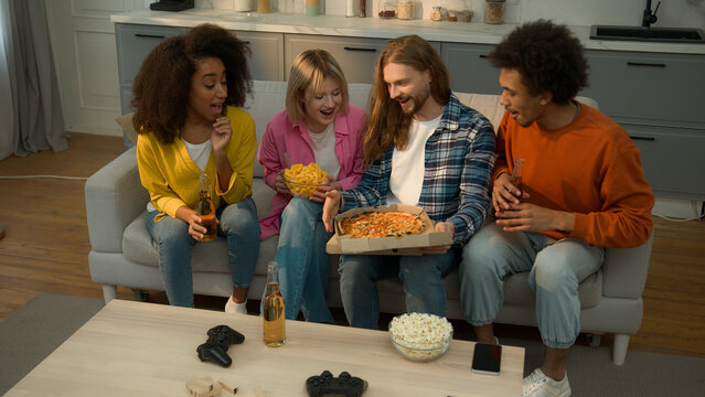 Food delivery service multiracial African Caucasian people friends diversity together gathering party man bring beer bottles pizza men women girls guys friendship home females males party watching tv