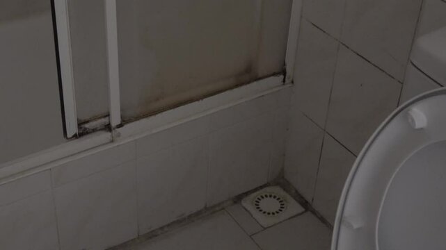 Tuzla, Istanbul, Turkey - 26th of February 2024: 4K Mouldy corner in the dark nasty bathroom
