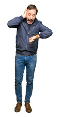 Naklejka premium Middle age handsome man wearing a jacket Looking at the watch time worried, afraid of getting late