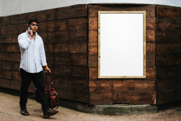 Wooden frame png mockup psd on a brick wall with a man passing by