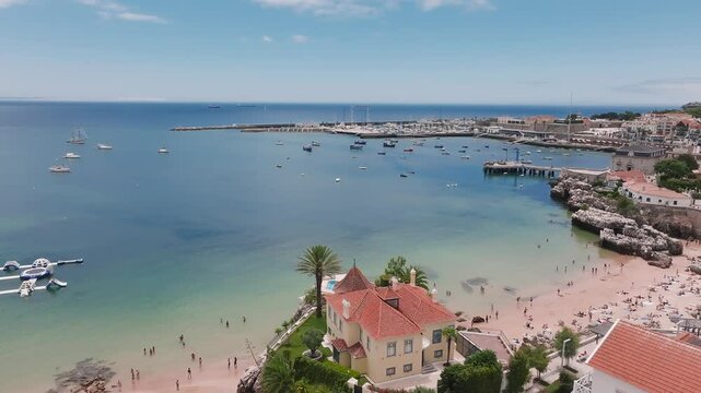 Aerial panoramic view of Praia da Rainha and historic city centre of Cascais, Portugal. Beautiful luxury hotels by the beach in Cascais.