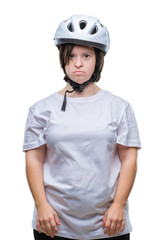 Young adult cyclist woman with down syndrome wearing safety helmet over isolated background with serious expression on face. Simple and natural looking at the camera.