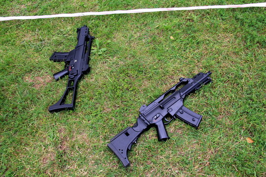 Riga, Latvia, 04 july, 2024: Ak 105 airsoft gun with reddot aimpoint on the ground in green grass. Air Gun. Toy Gun