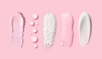 creamy texture of cosmetic samples on pink background
