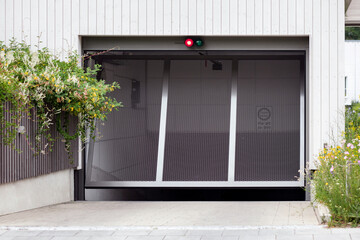 Garage Door with Traffic light of Underground Parking of Apartment Building. Modern Garage Doors of...