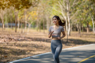 A woman is running on a path in a park