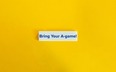 Bring Your A-game Motivational Slang Expression. Blue Text on Letter Tile against Yellow Background.