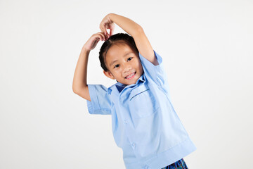 Portrait smile Asian little girl kindergarten showing heart shape sign with hands studio isolated white background, happy woman kid wear school uniform arms raised above her head, back to school