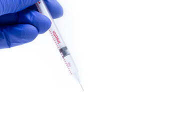 Doctor in blue gloves holding syringe on white background