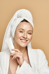 A woman with natural beauty gracefully poses with a towel wrapped around her head, exuding tranquility and elegance.