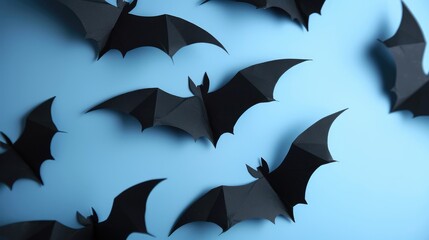 Scary Halloween decor Black paper bats over blue backdrop