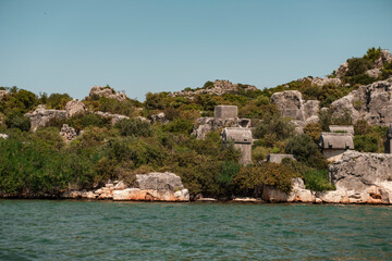 lycian tlos ancient city tombs, sarcophagus shaped architectural historical site, kekova island, view from sea