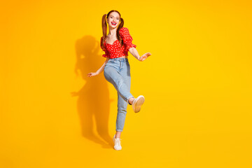 Photo of young red hair funky positive girl wearing blouse and jeans dancing moves corporate party isolated on yellow color background