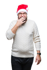 Young caucasian man wearing christmas hat and glasses over isolated background looking stressed and nervous with hands on mouth biting nails. Anxiety problem.