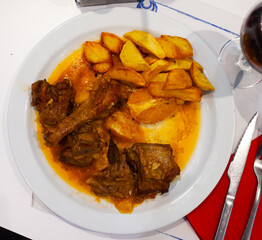Delicious crispy roasted duck with orange served with potato on white plate