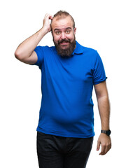 Fototapeta premium Young caucasian hipster man wearing blue shirt over isolated background confuse and wonder about question. Uncertain with doubt, thinking with hand on head. Pensive concept.