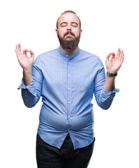 Young caucasian hipster man over isolated background relax and smiling with eyes closed doing meditation gesture with fingers. Yoga concept.