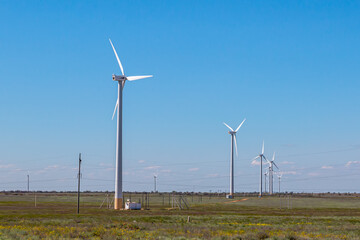 Wind farm in a field on a clear sunny day
