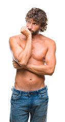Fototapeta premium Handsome hispanic model man sexy and shirtless over isolated background looking stressed and nervous with hands on mouth biting nails. Anxiety problem.