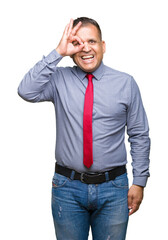 Middle age arab man wearing red tie over isolated background doing ok gesture with hand smiling, eye looking through fingers with happy face.