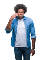 Afro american man talking on the phone over isolated background scared in shock with a surprise face, afraid and excited with fear expression