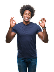 Afro american man over isolated background relax and smiling with eyes closed doing meditation gesture with fingers. Yoga concept.