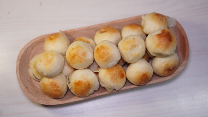 The pile of mooncakes on the wood plate. Typical cake like mooncake in Yogyakarta.