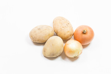 potatoes and onions stand on a white background