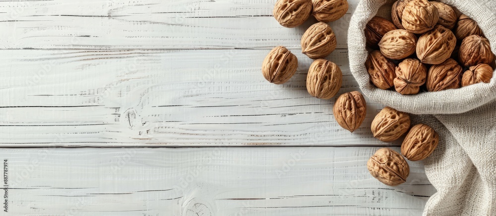 Poster walnuts arranged on a white wooden surface closed nuts in a cotton bag peeled kernels on a table hig