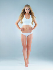 Underwear, woman or portrait in studio for pride, healthy body or self assurance on mockup space. Beauty, female person or hair care on blue background with fitness results, confidence or fearless