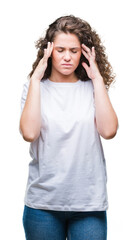 Beautiful brunette curly hair young girl wearing casual t-shirt over isolated background with hand on head for pain in head because stress. Suffering migraine.