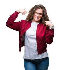 Beautiful brunette curly hair young girl wearing jacket and glasses over isolated background...