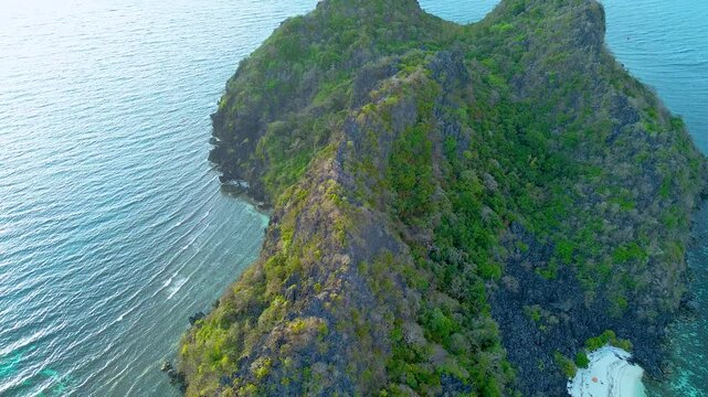 Join us on a serene journey over a hidden island near Coron, Philippines. This drone footage captures the early morning ambiance with a campsite peacefully nestled among lush vegetation and rugged cli
