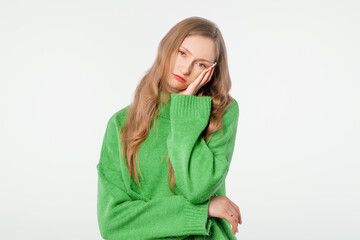 You waste my time on stupid talks. Bothered and bored cute blonde female, wears winter sweater...
