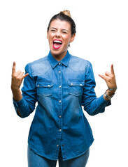 Young beautiful woman over isolated background shouting with crazy expression doing rock symbol with hands up. Music star. Heavy concept.