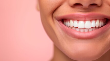 Fototapeta premium Close-Up of Smiling Woman with Bright White Teeth on Light Pink Background Highlighting Dental Health, Beauty, and Happiness