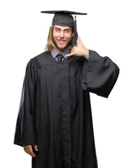 Young handsome graduated man with long hair over isolated background smiling doing phone gesture with hand and fingers like talking on the telephone. Communicating concepts.