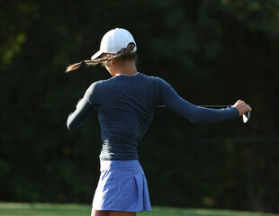 Young lady golf stretching