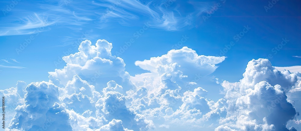 Poster background of a clear blue sky with fluffy white clouds suitable for copy space image