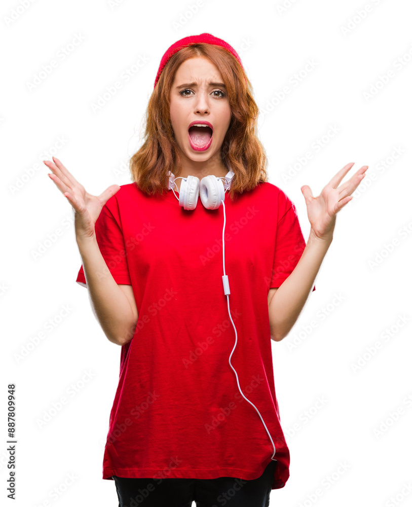 Canvas Prints young beautiful hipster woman over isolated background wearing headphones and cap celebrating crazy 